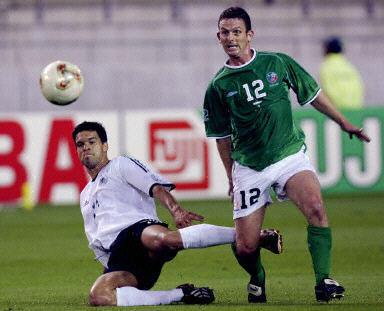 Photographer KAZUHIRO NOGI, "Irish midfielder Mark Kinsella (R) kicks the ball in front of German midfielder Michael Ballack during the Group E first round match Germany/Ireland of the 2002 FIFA World Cup in Korea and Japan, 05 June 2001 at Kashima Ibaraki Stadium." AFP PHOTO