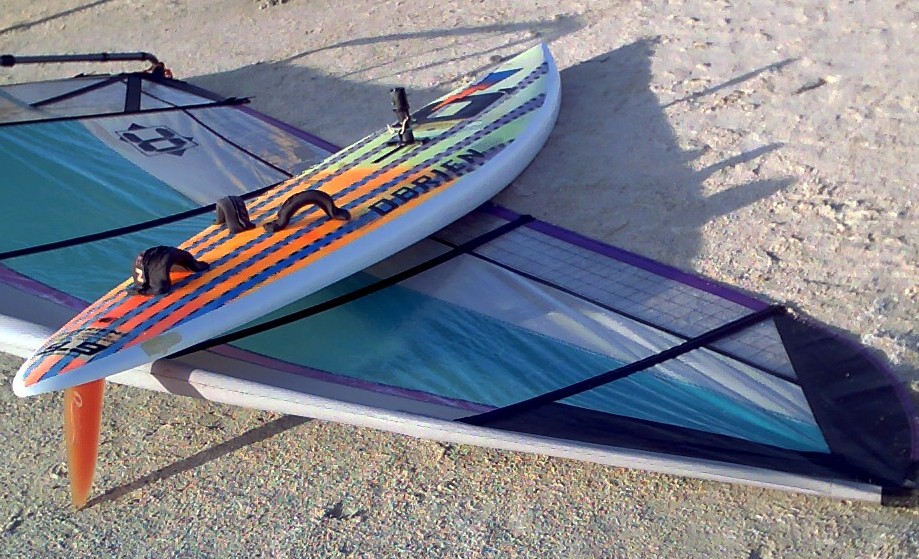 Mike Kimbro's Aerotech 7.5 sail behind his vintage 1989 O'Brien Epoxy Lite 9.9 windsurfer, complete with Rainbow fin and Streamlined universal.  Photo taken at Bird Island Basin just south of Corpus Christi, Texas.