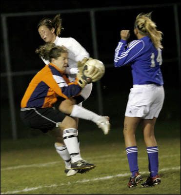 Photo Credit:  by Joe Vitti of The Indianapolis Star, Noblesville's Allie Vandewater (in white) collides with Carmel High School goalkeeper Emma Gormley. Carmel's Jessica Rix is at right.