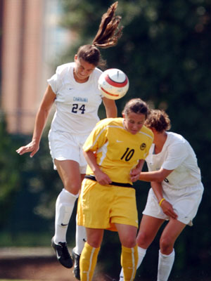 Photo Credit:  North Carolina's sports information dept, photo of 5' 9" Tarheel junior All-American defender Jessica Maxwell #24 executing a text book header in the direction of the keeper's feet.