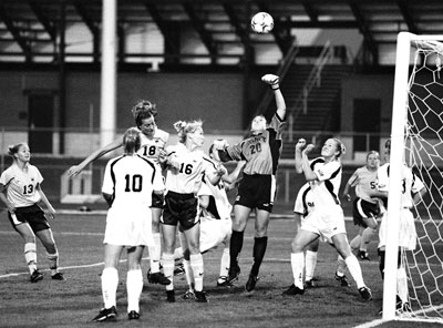 Photo by Travis Mathews, staff photographer for www.themaneater.com on September 14, 2001. Displayed with the caption: Drury goalkeeper Britt, flanked by a host of Missouri players, punches the ball away...